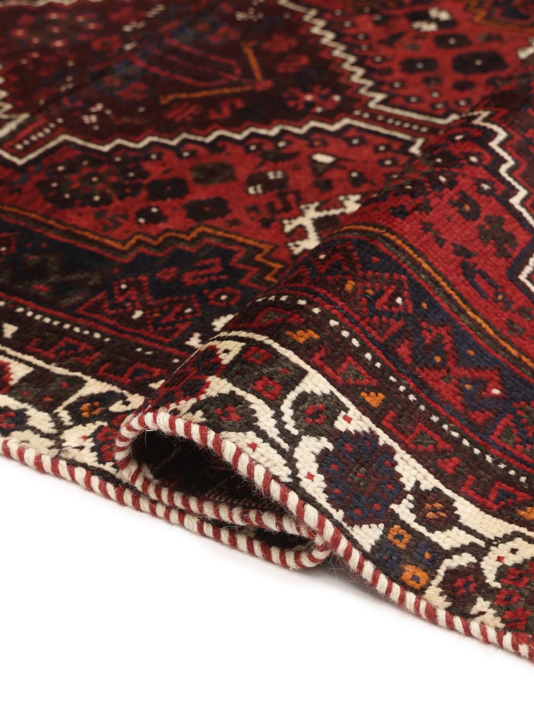 Hand-knotted Shiraz rug in dark red and black with tribal geometric patterns