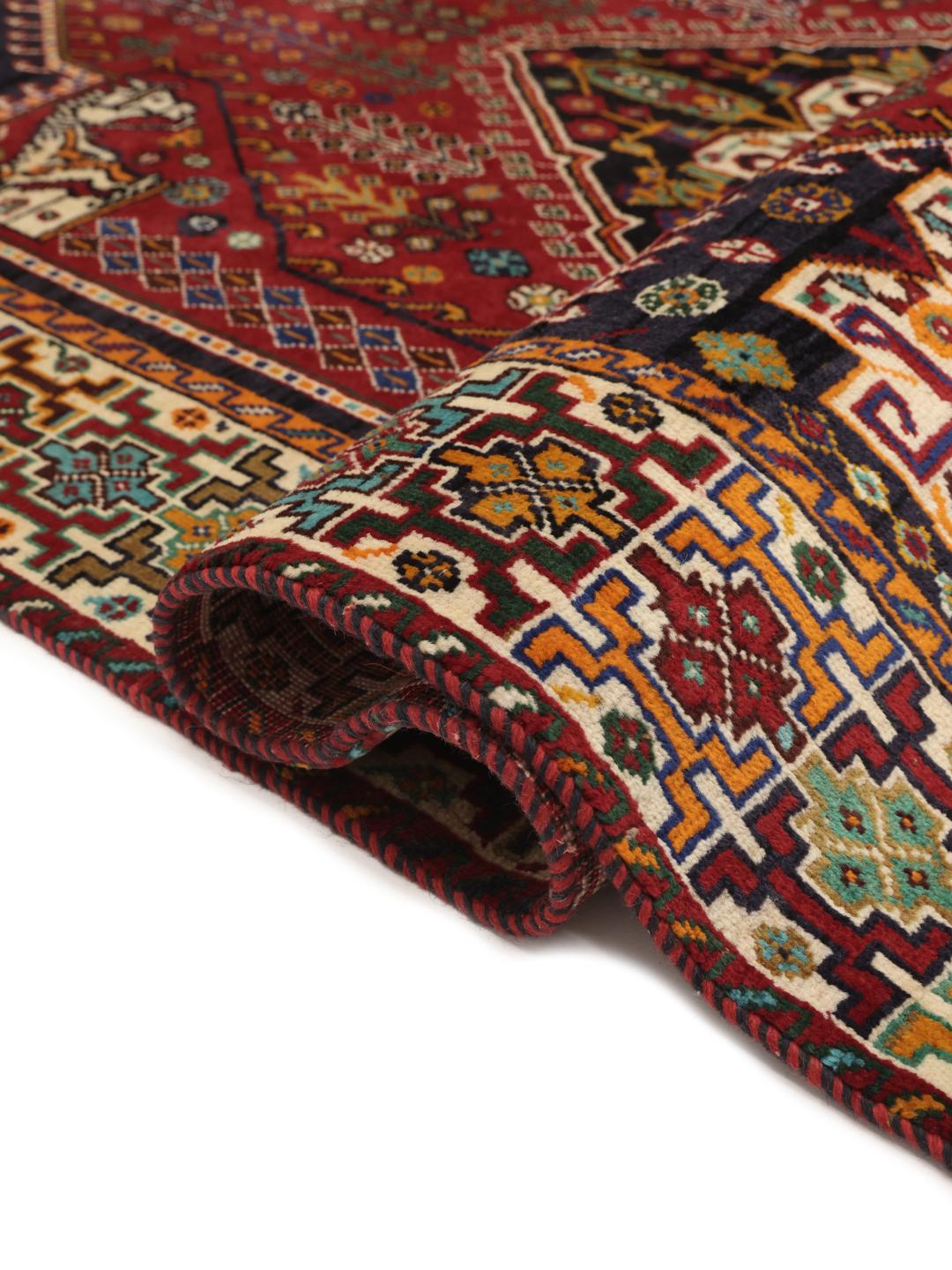 Hand-knotted Ghashghai rug from the Middle East with a red and dark-blue wool pile
