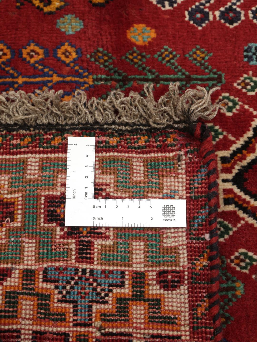 Hand-knotted Ghashghai rug from the Middle East with a red and dark-blue wool pile