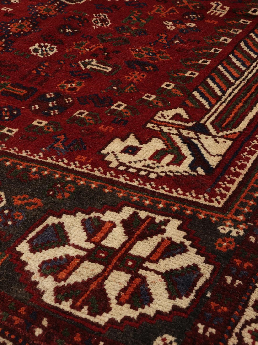 Hand-knotted Shiraz rug from the Middle East in deep red and blue tones