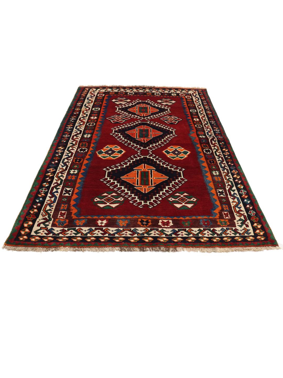 Hand-knotted Qashqai rug from the Middle East with a red field and geometric patterns