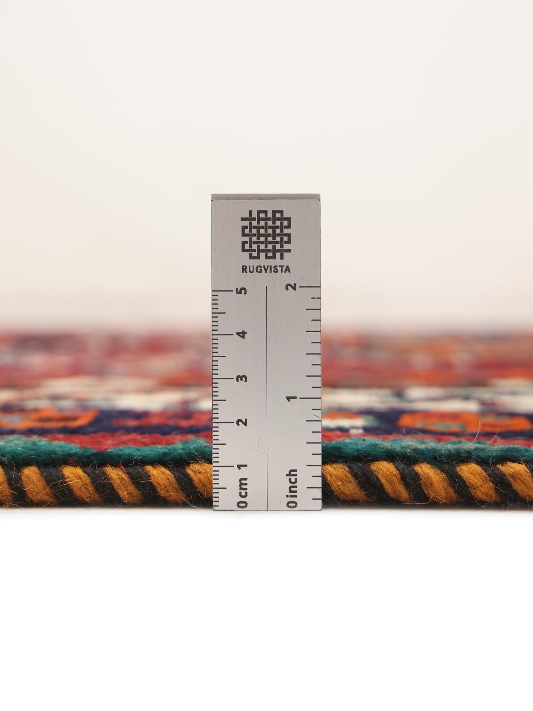 Hand-knotted Qashqai rug from the Middle East with a red field and geometric patterns