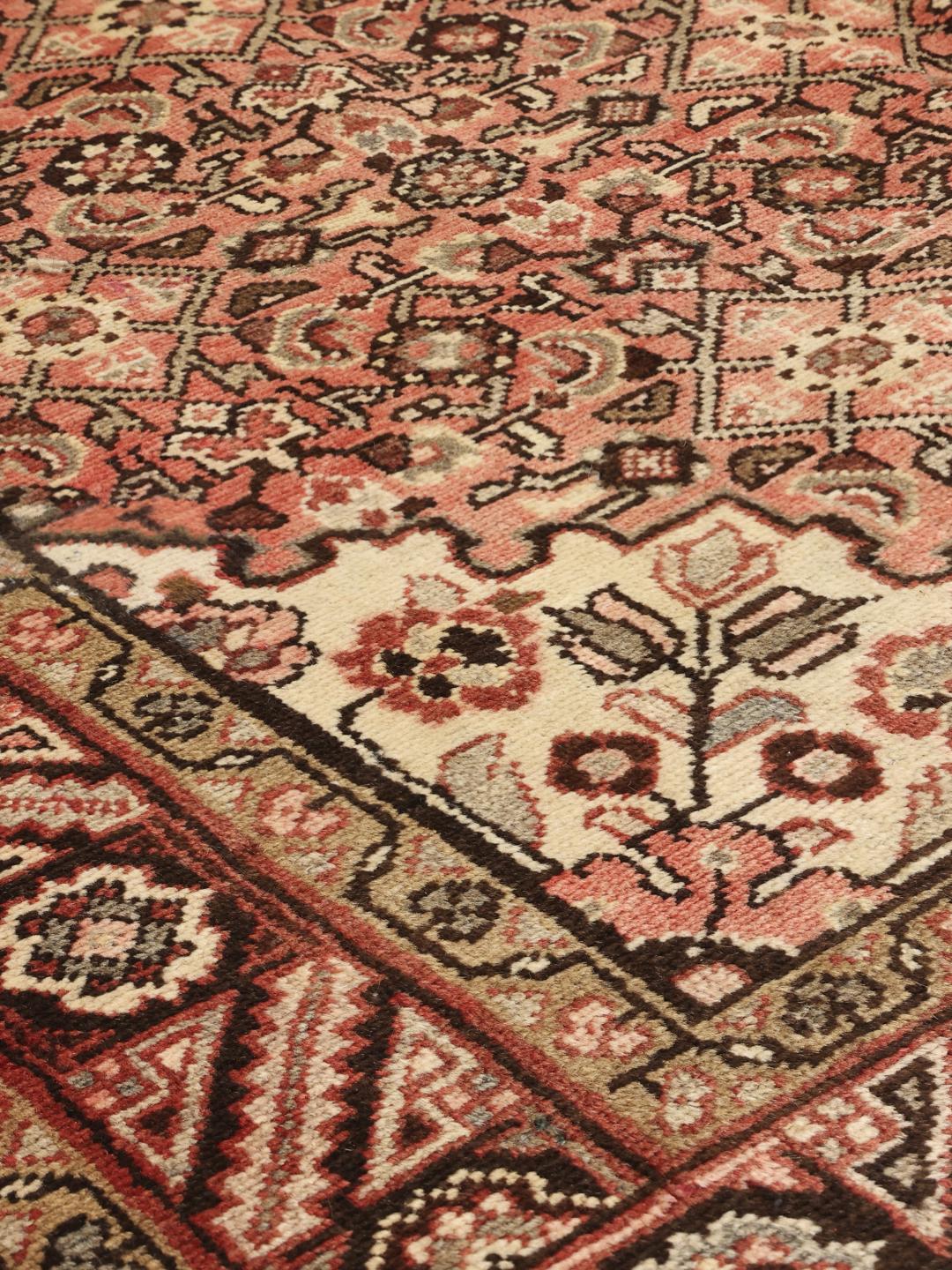 Hand-knotted Hosseinabad rug from the Middle East in red and cream tones