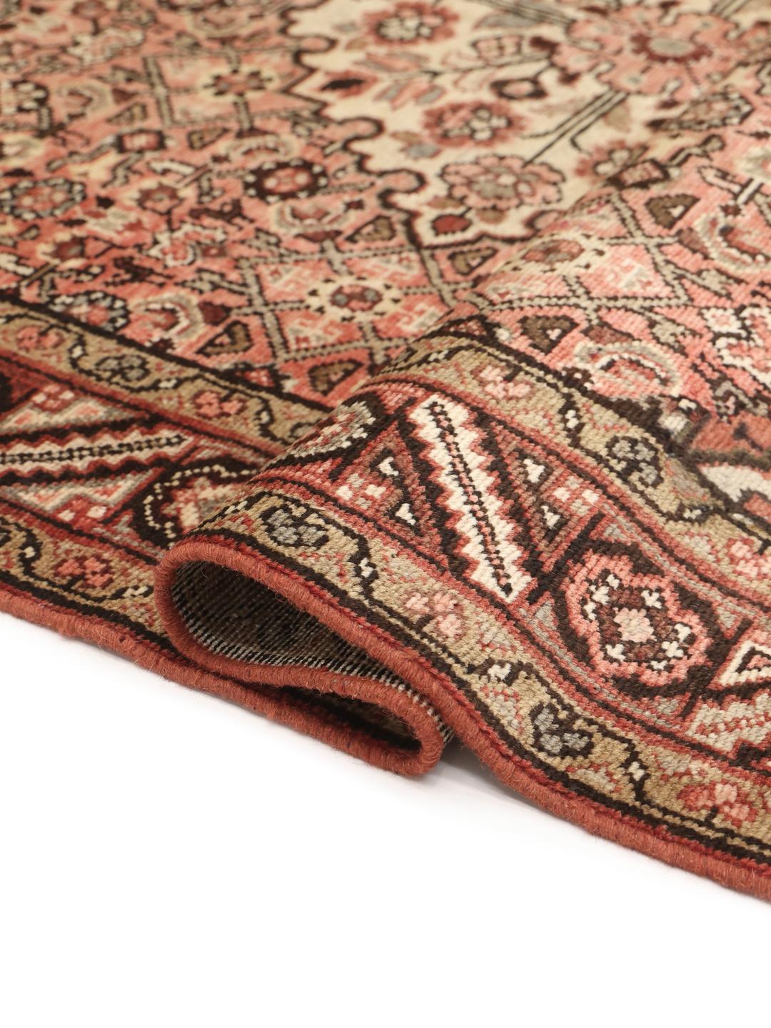 Hand-knotted Hosseinabad rug from the Middle East in red and cream tones