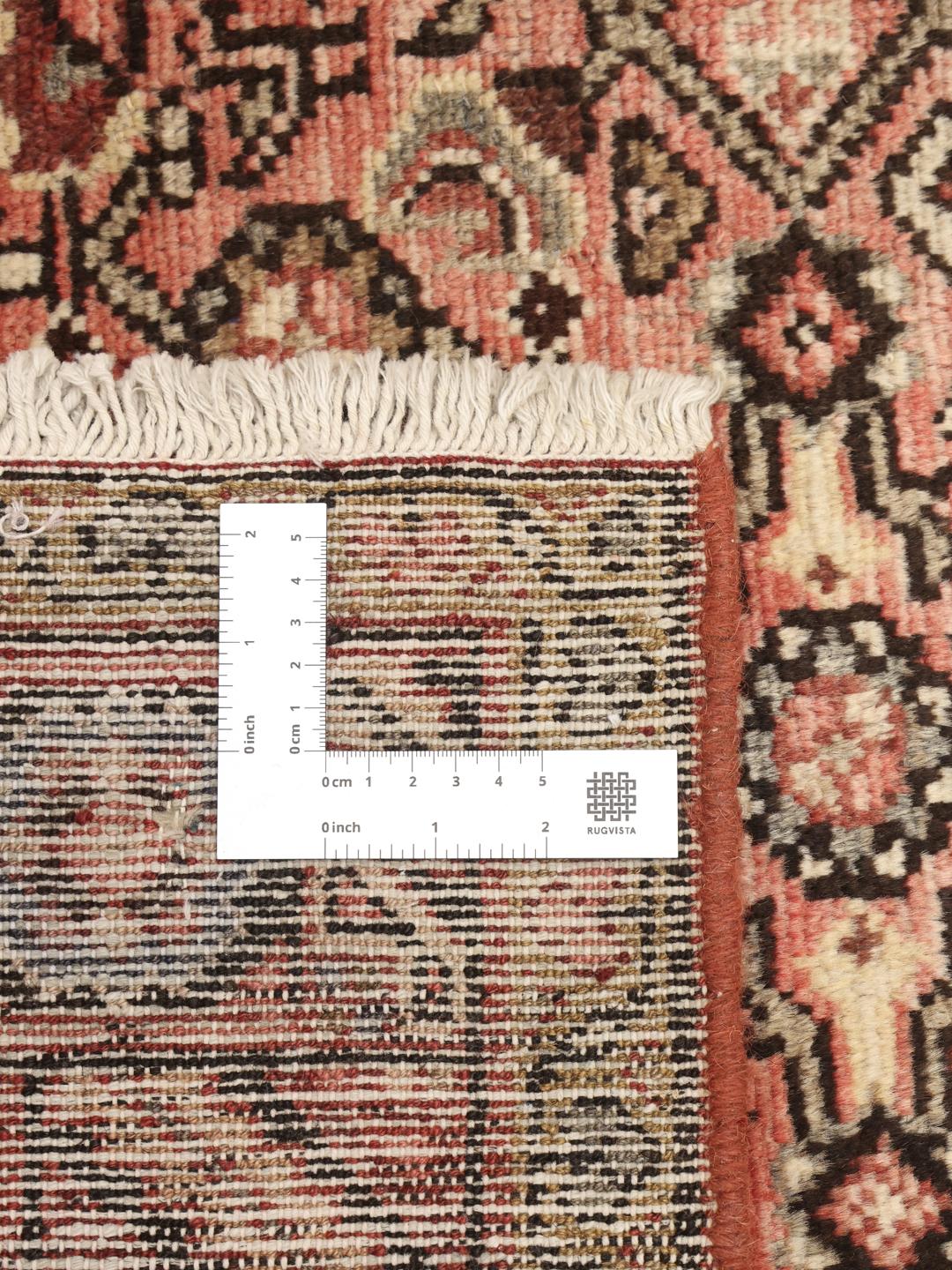 Hand-knotted Hosseinabad rug from the Middle East in red and cream tones