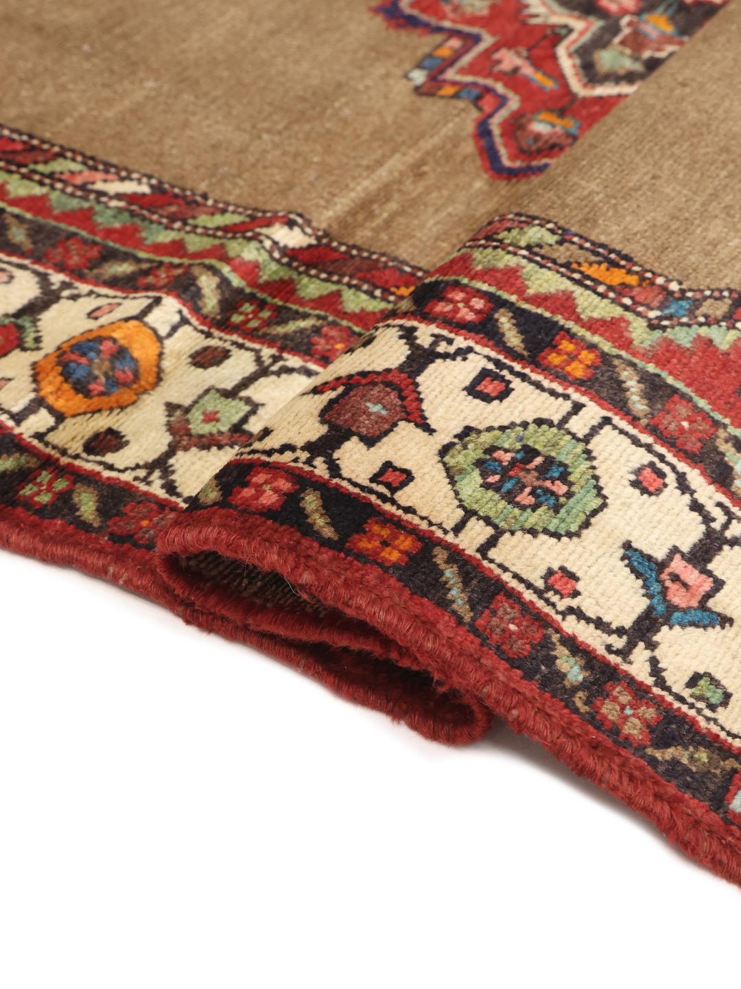 Hand-knotted wool rug from the Middle East in warm brown and red tones