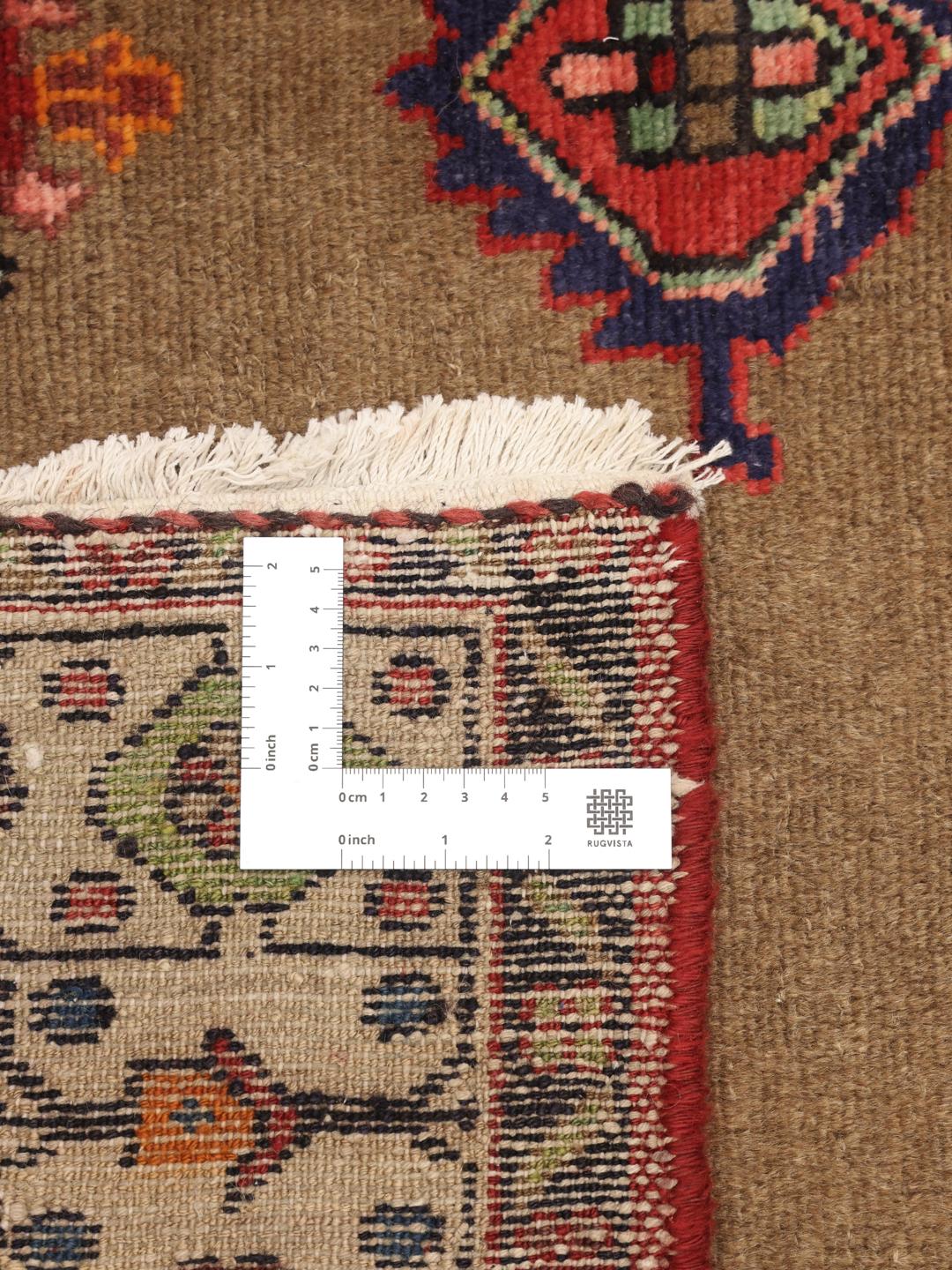 Hand-knotted wool rug from the Middle East in warm brown and red tones