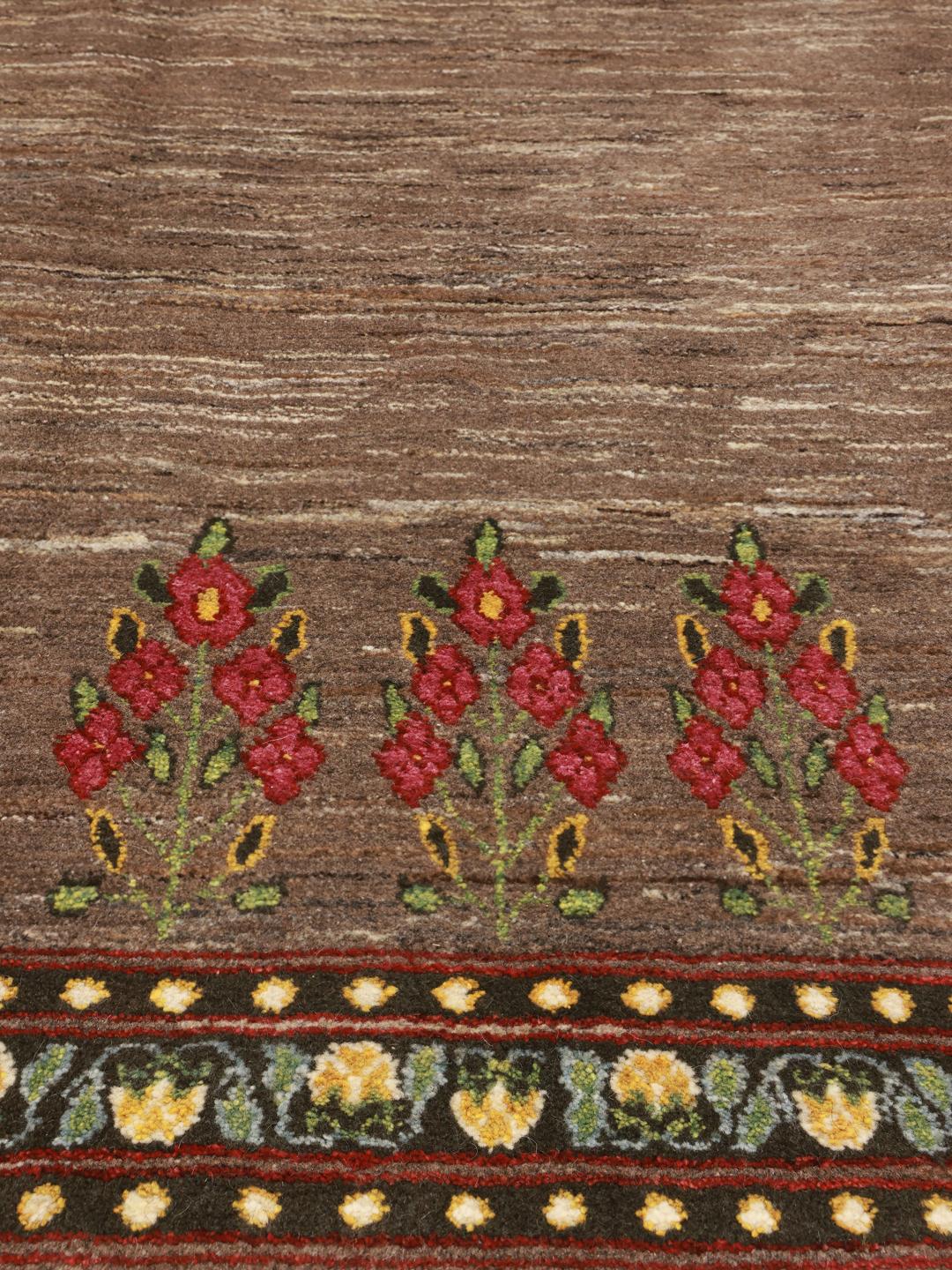 Hand-knotted Loribaft rug from the Middle East featuring floral patterns on a brown background.