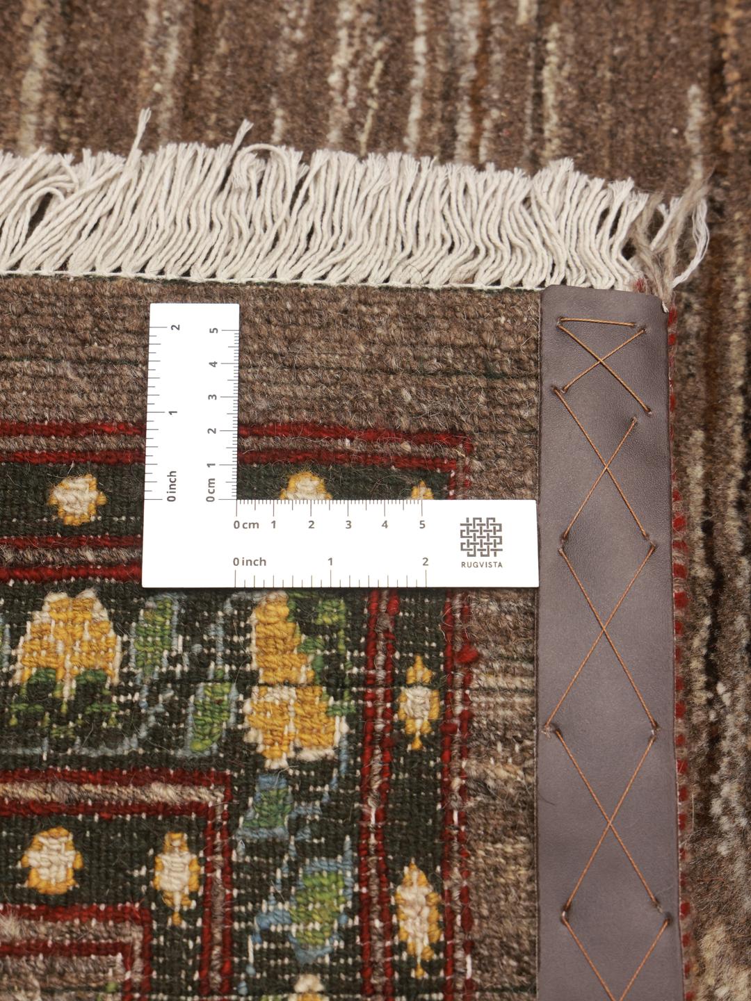 Hand-knotted Loribaft rug from the Middle East featuring floral patterns on a brown background.