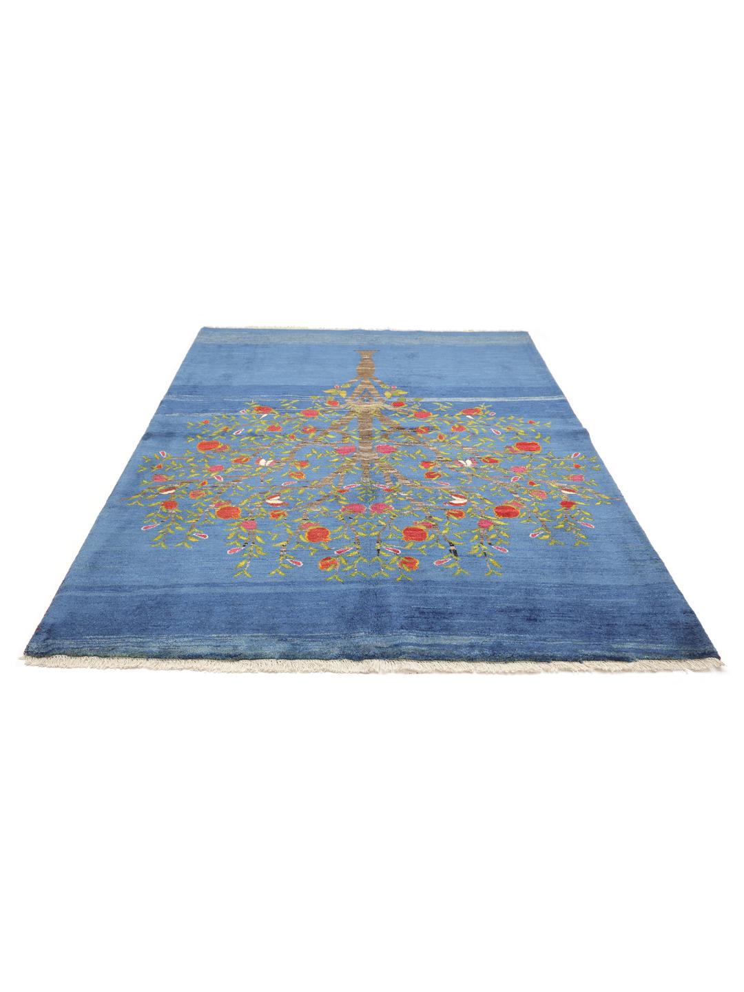 A hand-knotted Loribaft rug from the Middle East featuring a Tree of Life design on a blue field.