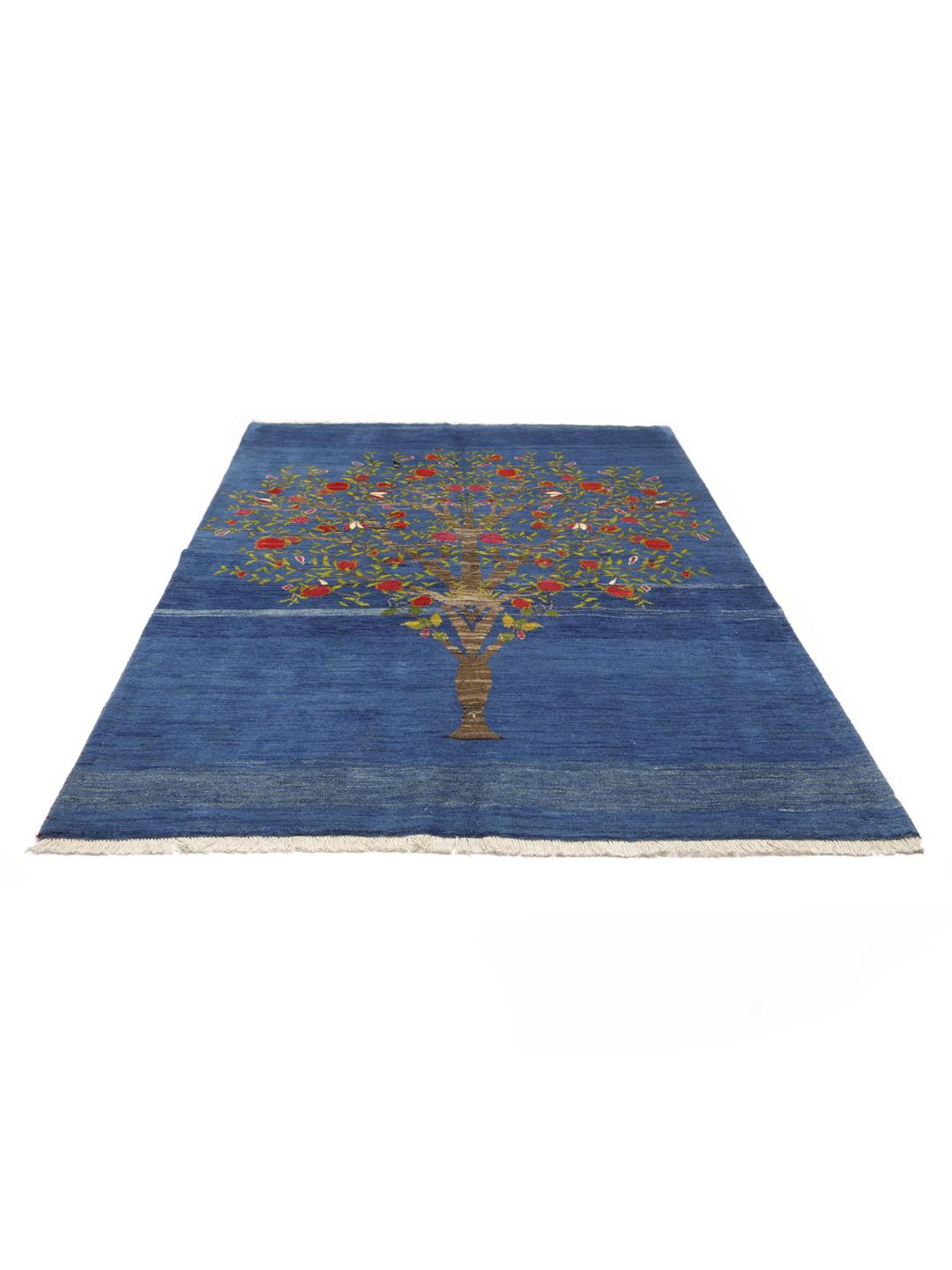 A hand-knotted Loribaft rug from the Middle East featuring a Tree of Life design on a blue field.