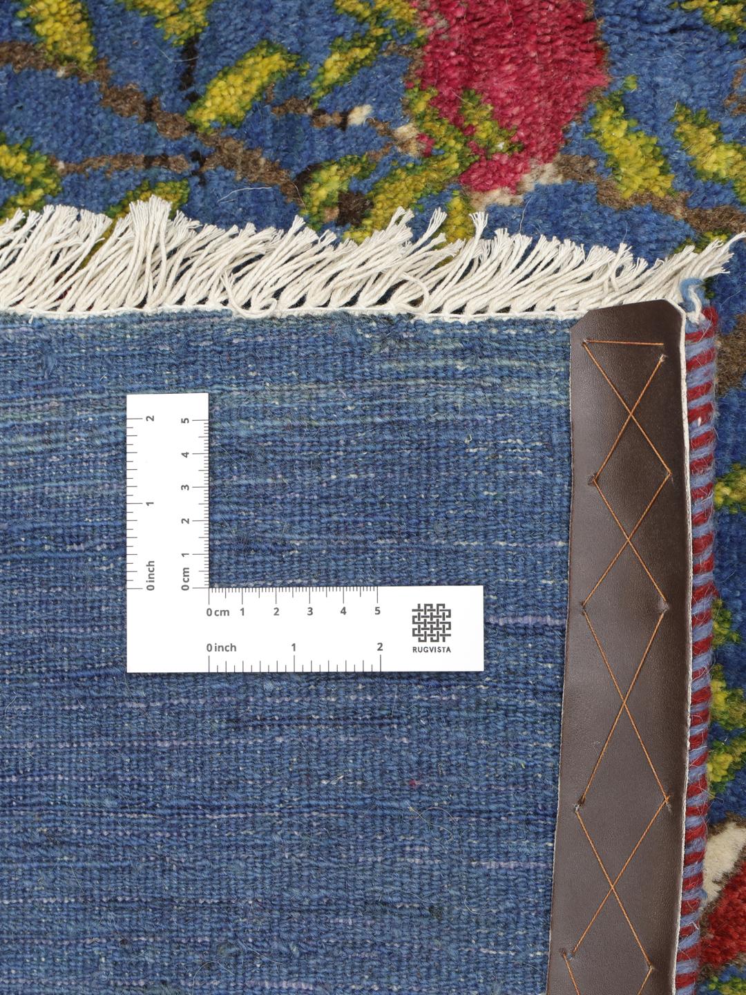 A hand-knotted Loribaft rug from the Middle East featuring a Tree of Life design on a blue field.