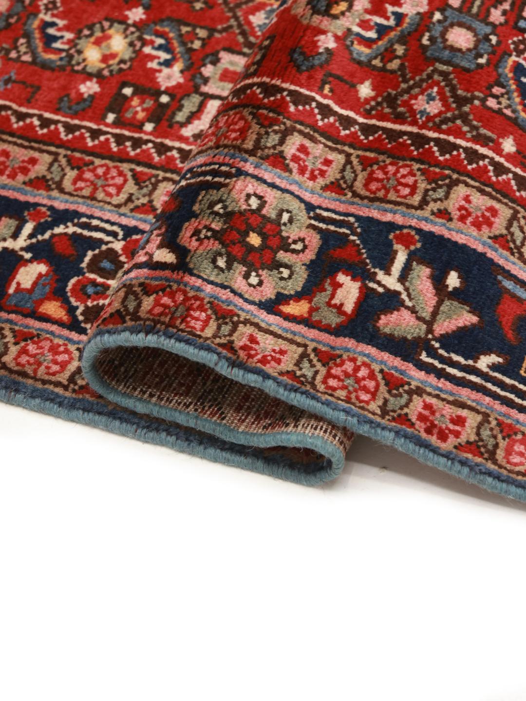 Hand-knotted Hosseinabad rug with a rich red field and decorative floral patterns