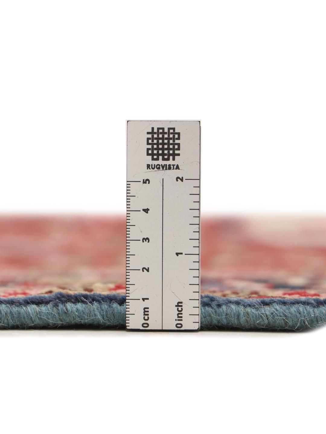 Hand-knotted Hosseinabad rug with a rich red field and decorative floral patterns