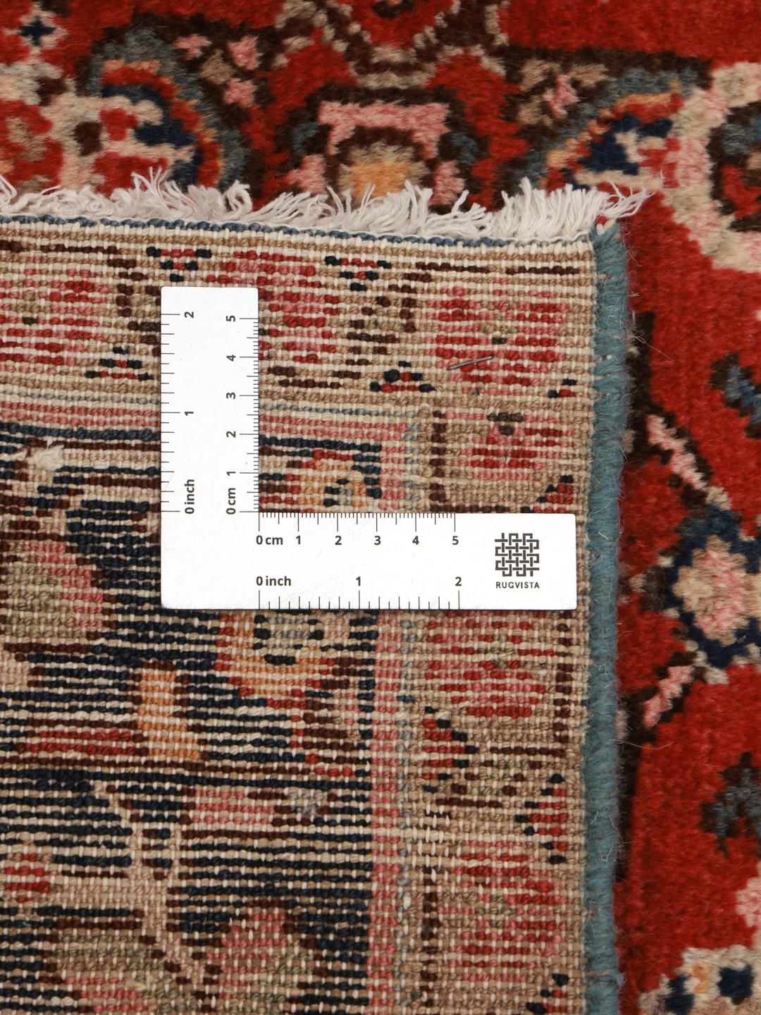 Hand-knotted Hosseinabad rug with a rich red field and decorative floral patterns