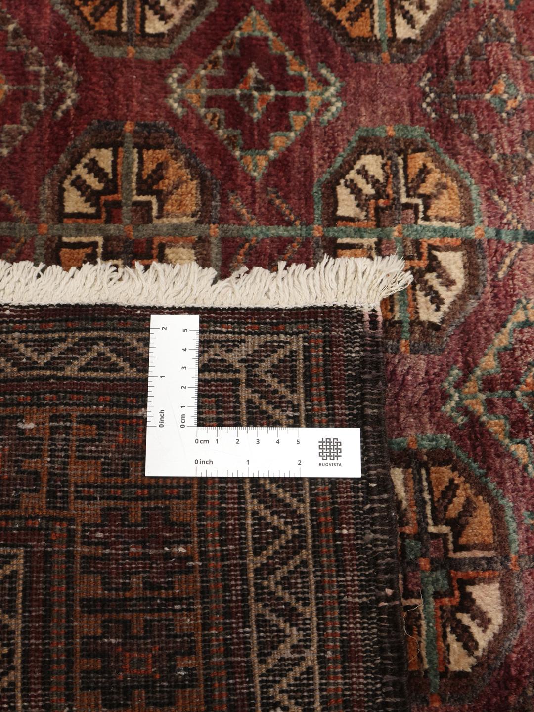Håndknyttet Baluch-tæppe med et mørkerødt felt og geometriske mønstre fra Mellemøsten