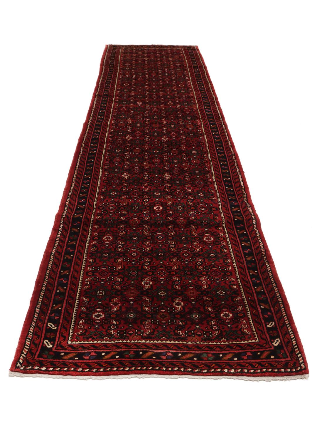 A long, hand-knotted Hosseinabad runner with a dark-red Wool pile and traditional Middle Eastern motifs.