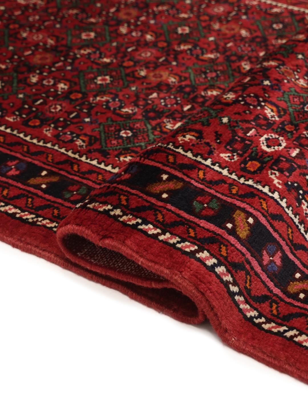 A long, hand-knotted Hosseinabad runner with a dark-red Wool pile and traditional Middle Eastern motifs.