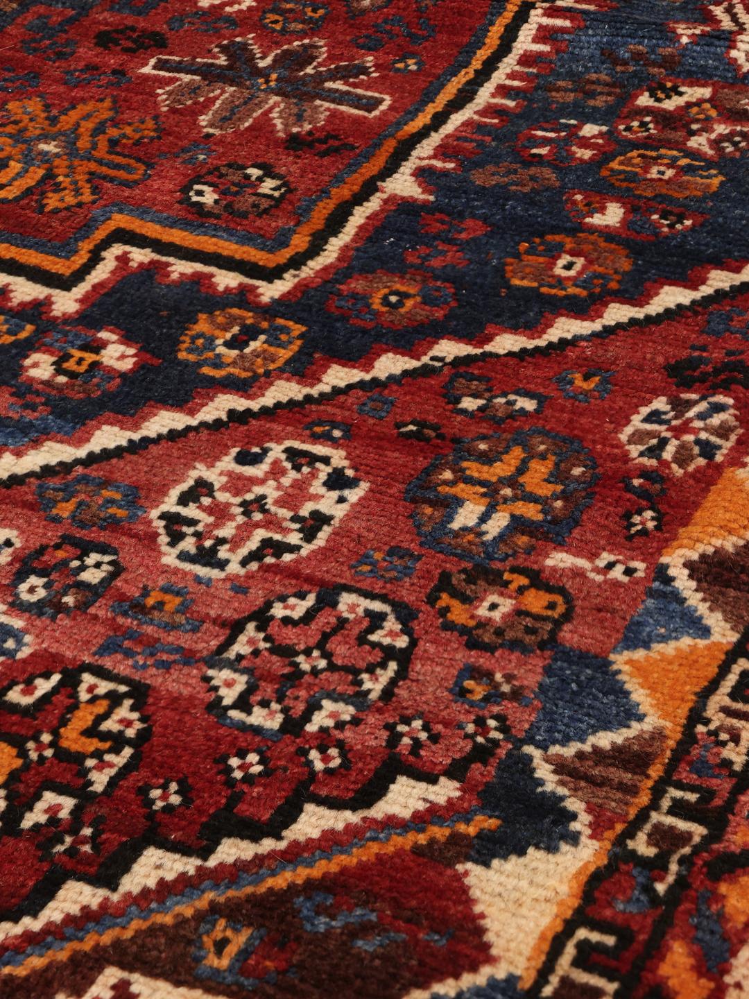 Hand-knotted Shiraz rug from the Middle East in red and blue tones