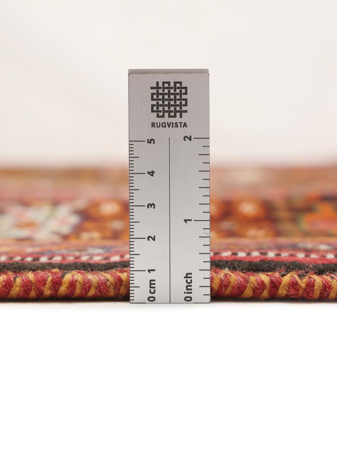 Hand-knotted Shiraz rug from the Middle East featuring a vibrant red field with geometric motifs.