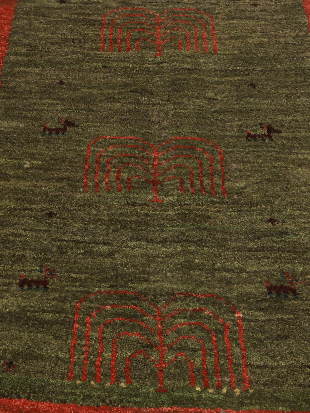 Hand-knotted Shabargan rug from the Middle East with green and red colour tones
