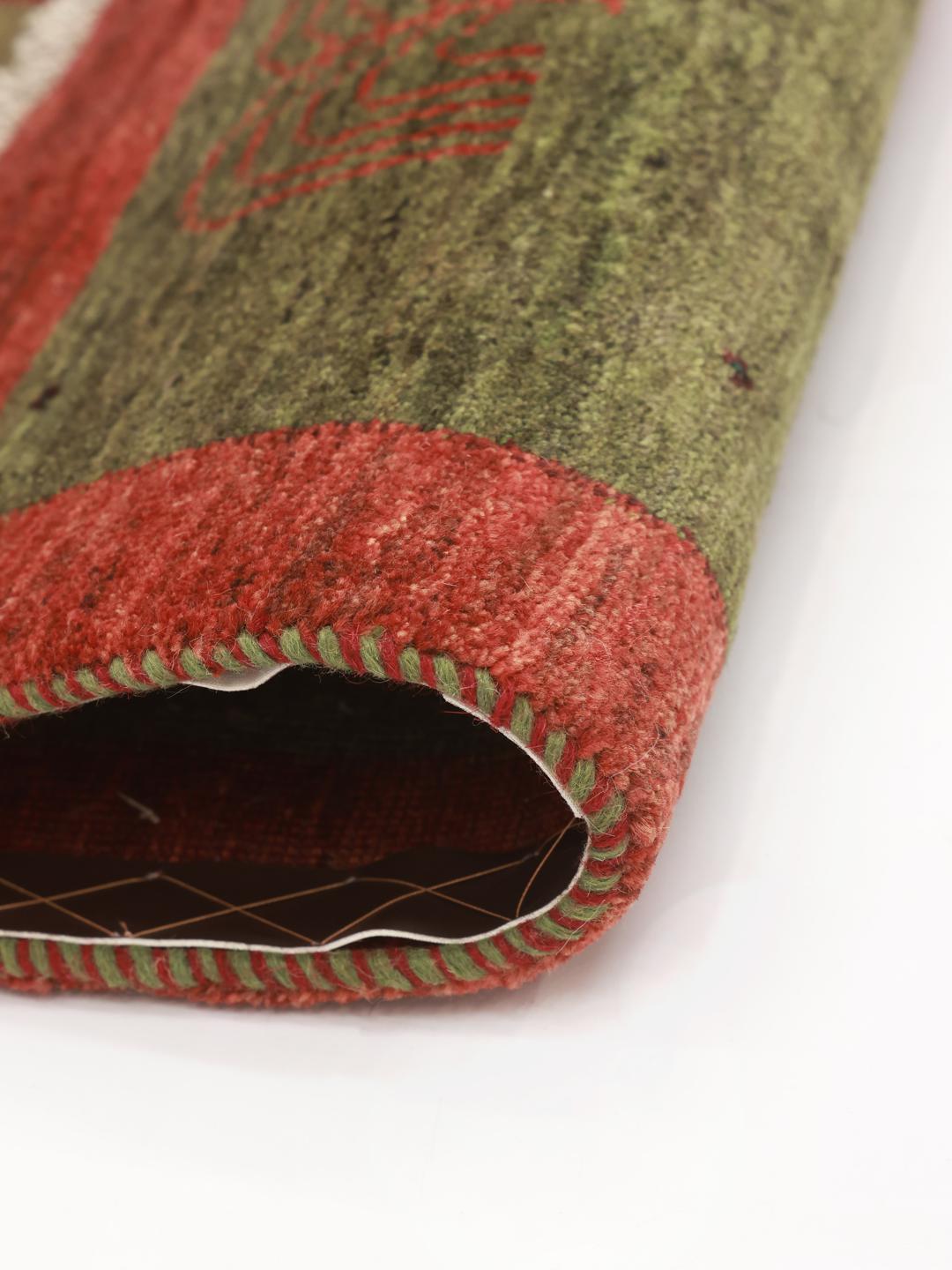 Hand-knotted Shabargan rug from the Middle East with green and red colour tones