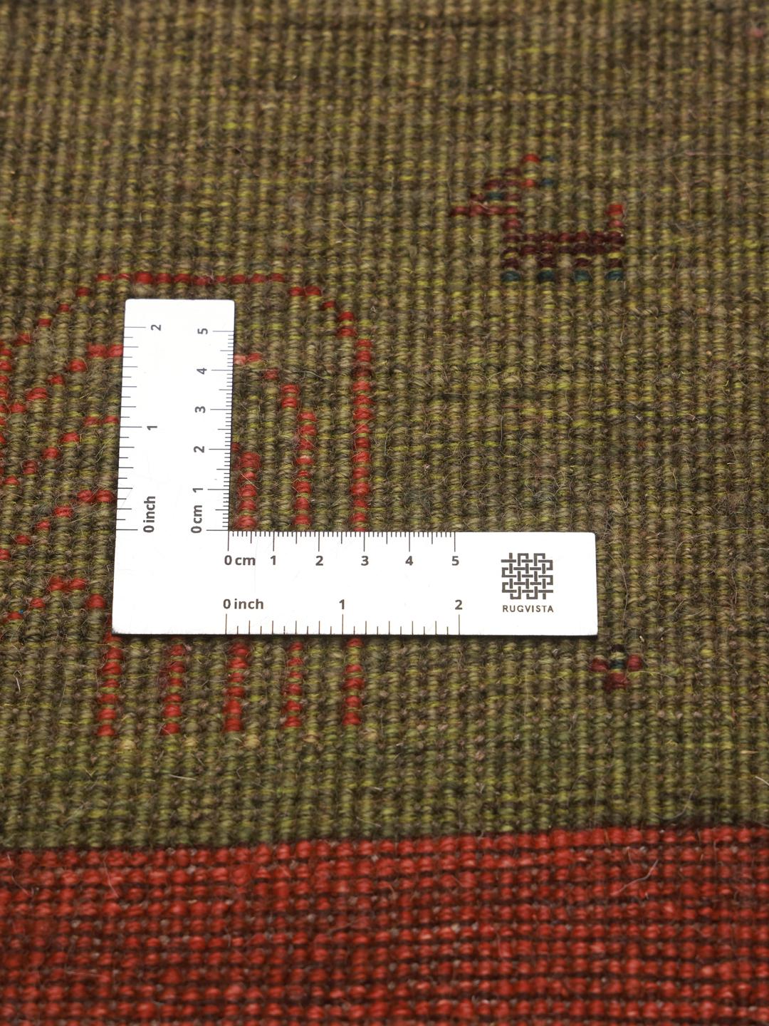 Hand-knotted Shabargan rug from the Middle East with green and red colour tones