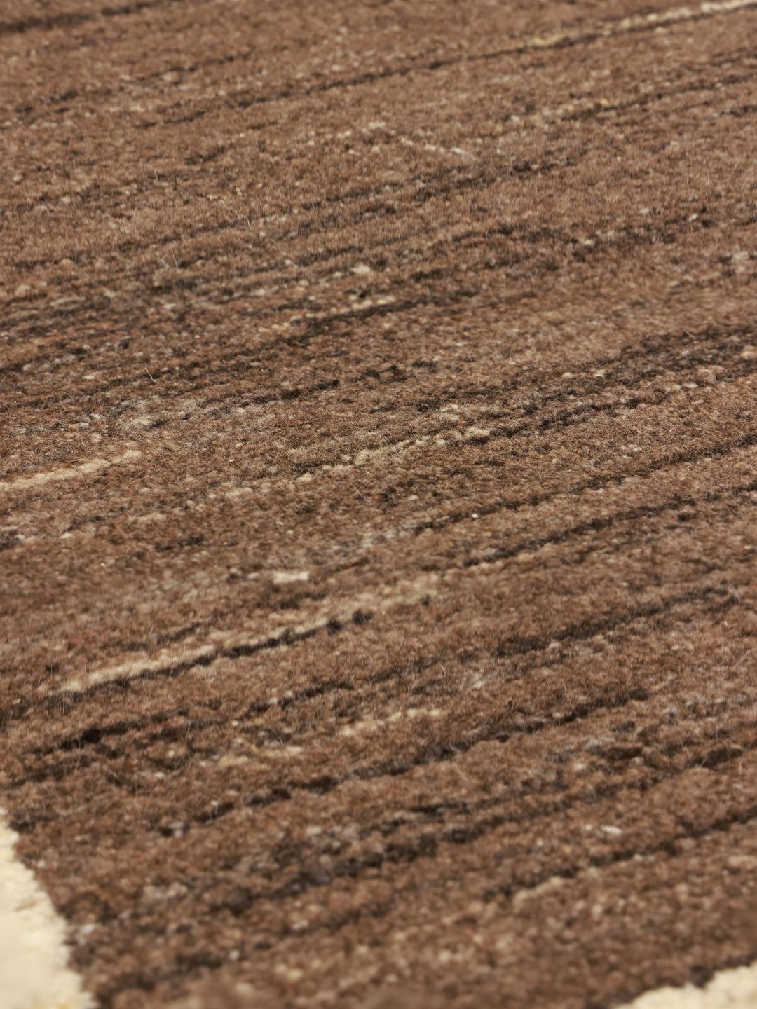 Hand-knotted Gabbeh rug with a brown field and beige border, Middle Eastern origin.
