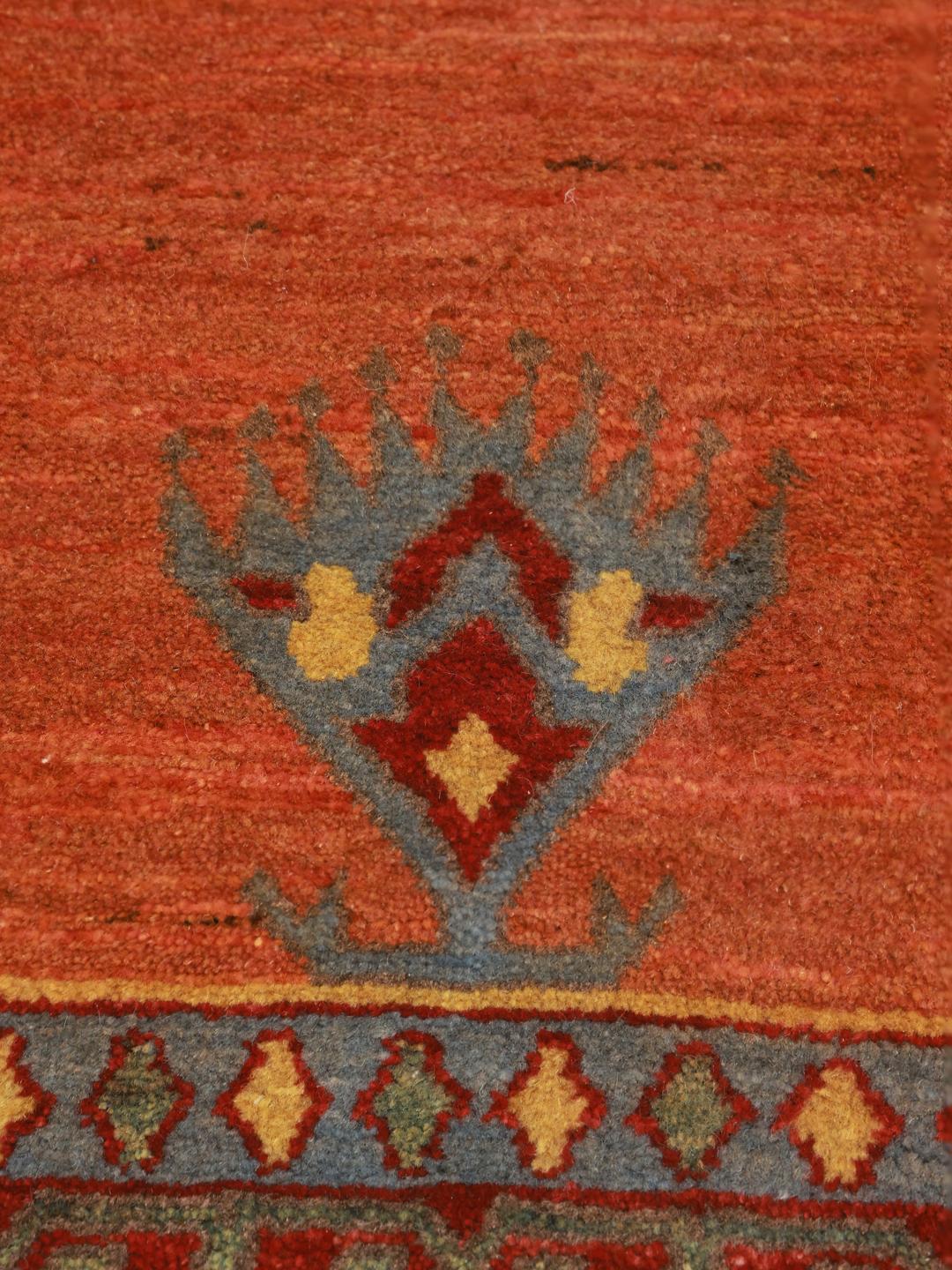 Hand-knotted Loribaft rug with a red field and geometric motifs