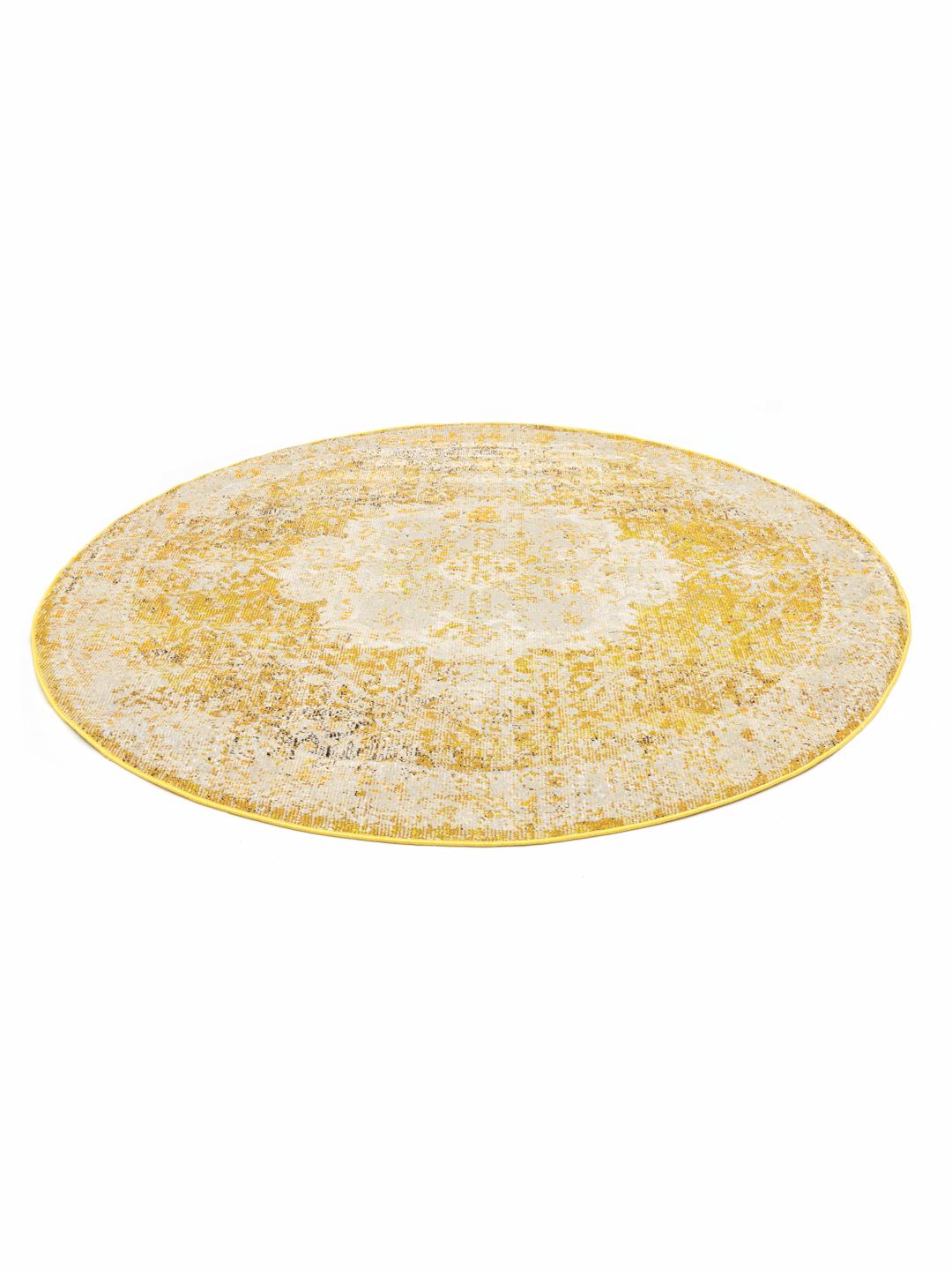 rond geel vloerkleed met een vaal medaillonpatroon
