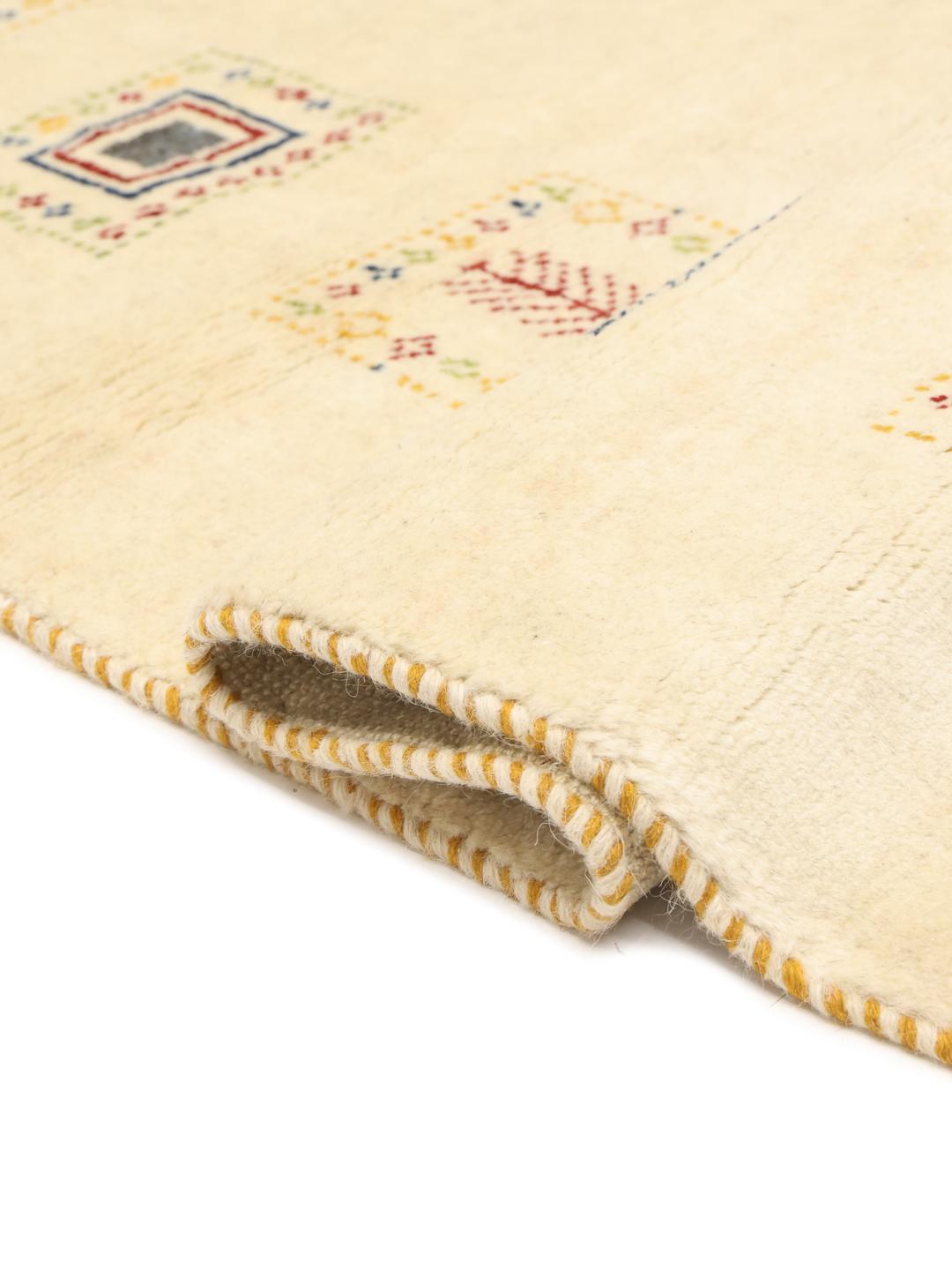 Hand knotted Gabbeh rug from the Middle East with a beige background and colourful motifs