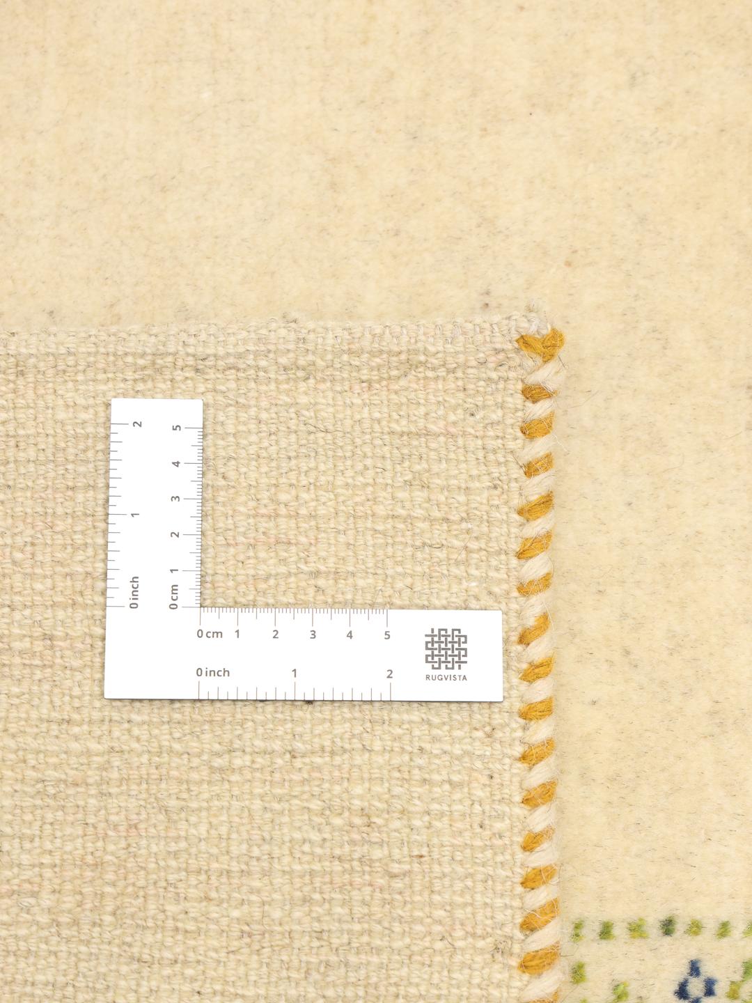 Hand knotted Gabbeh rug from the Middle East with a beige background and colourful motifs