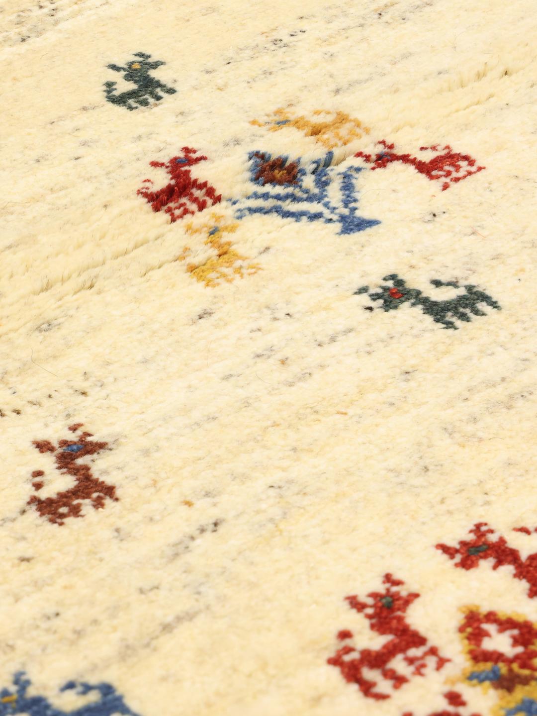 Hand-knotted Gabbeh rug with animal motifs on a cream wool field from the Middle East