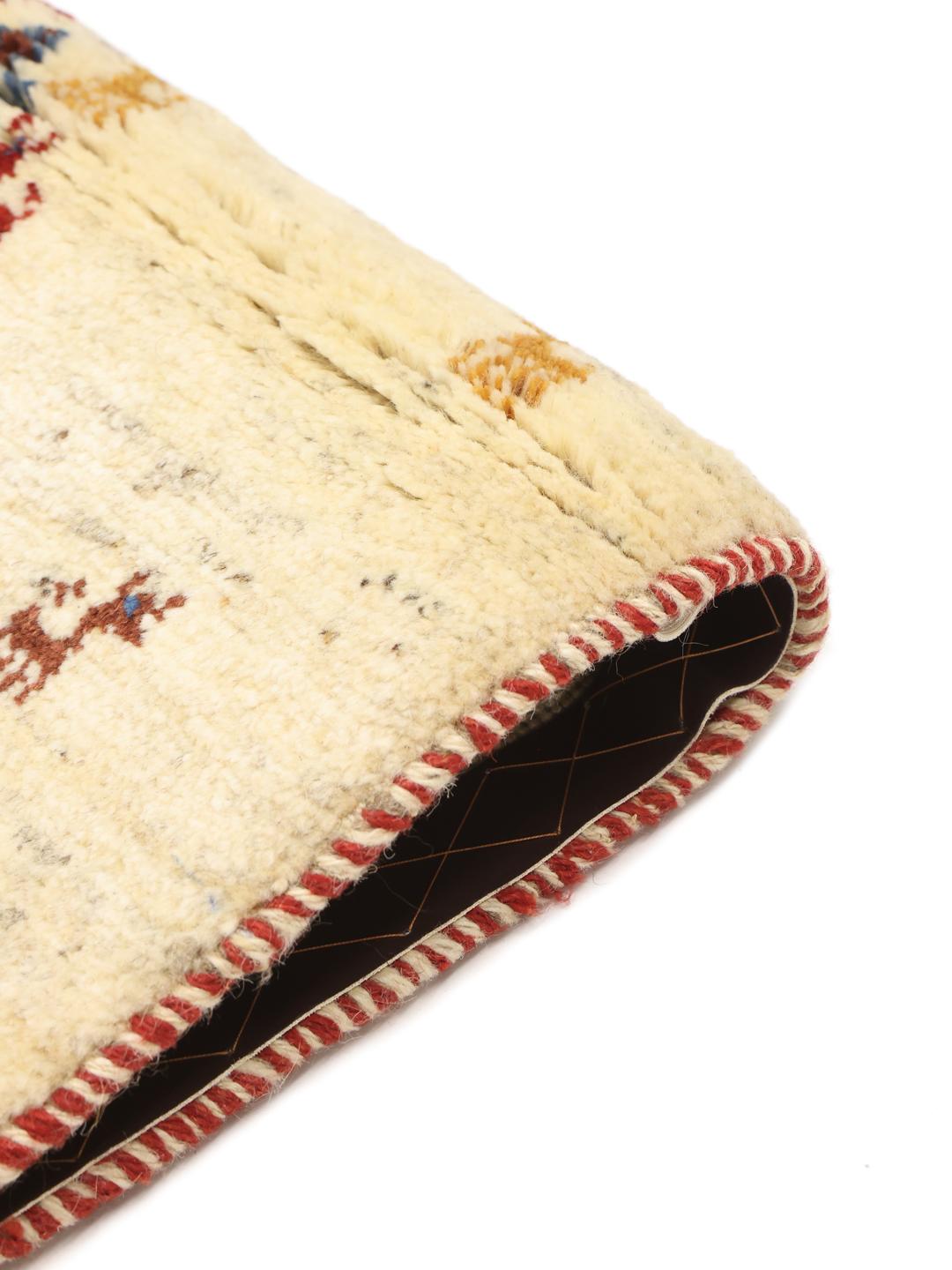 Hand-knotted Gabbeh rug with animal motifs on a cream wool field from the Middle East