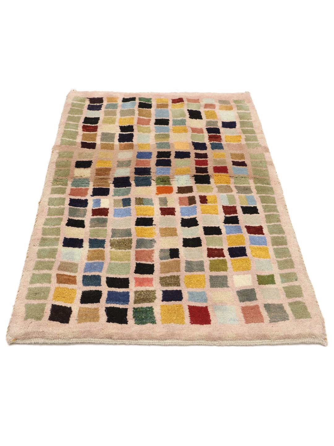 A hand-knotted Gabbeh rug from the Middle East with a multicoloured square grid pattern.