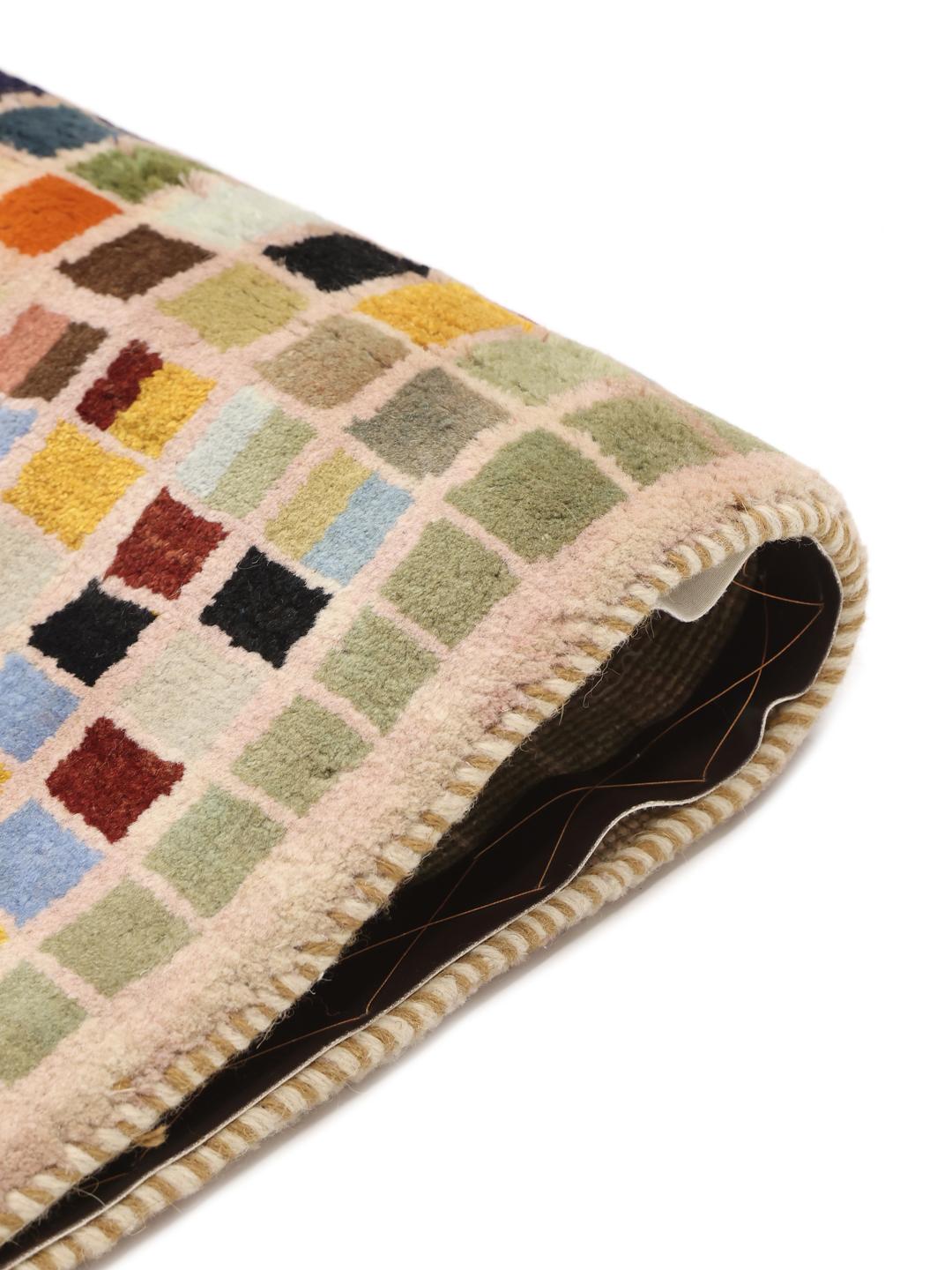 A hand-knotted Gabbeh rug from the Middle East with a multicoloured square grid pattern.