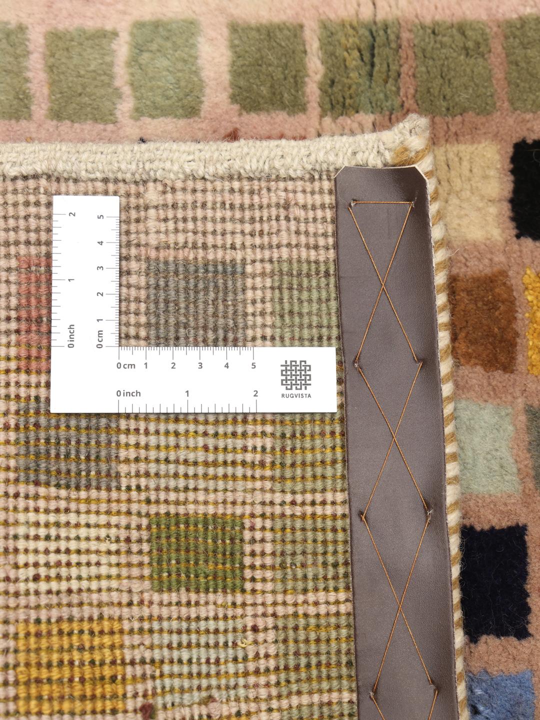 A hand-knotted Gabbeh rug from the Middle East with a multicoloured square grid pattern.