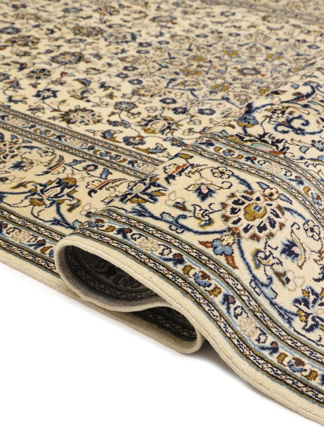 Hand-knotted Keshan rug with floral motifs and blue accents on a beige background from the Middle East