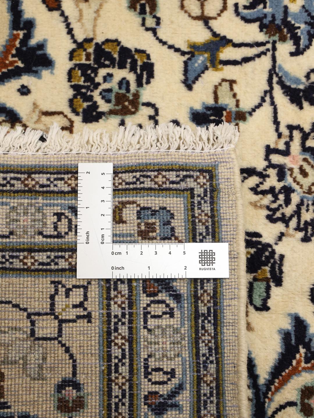 Hand-knotted Keshan rug with floral motifs and blue accents on a beige background from the Middle East