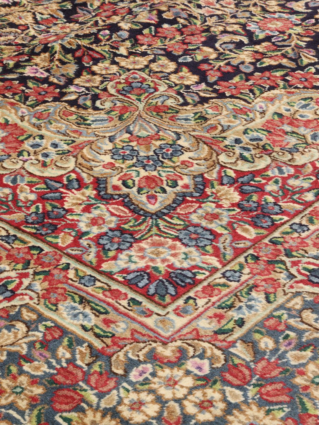 Tapis Kerman noué à la main provenant du Moyen-Orient, présentant un champ floral bleu foncé