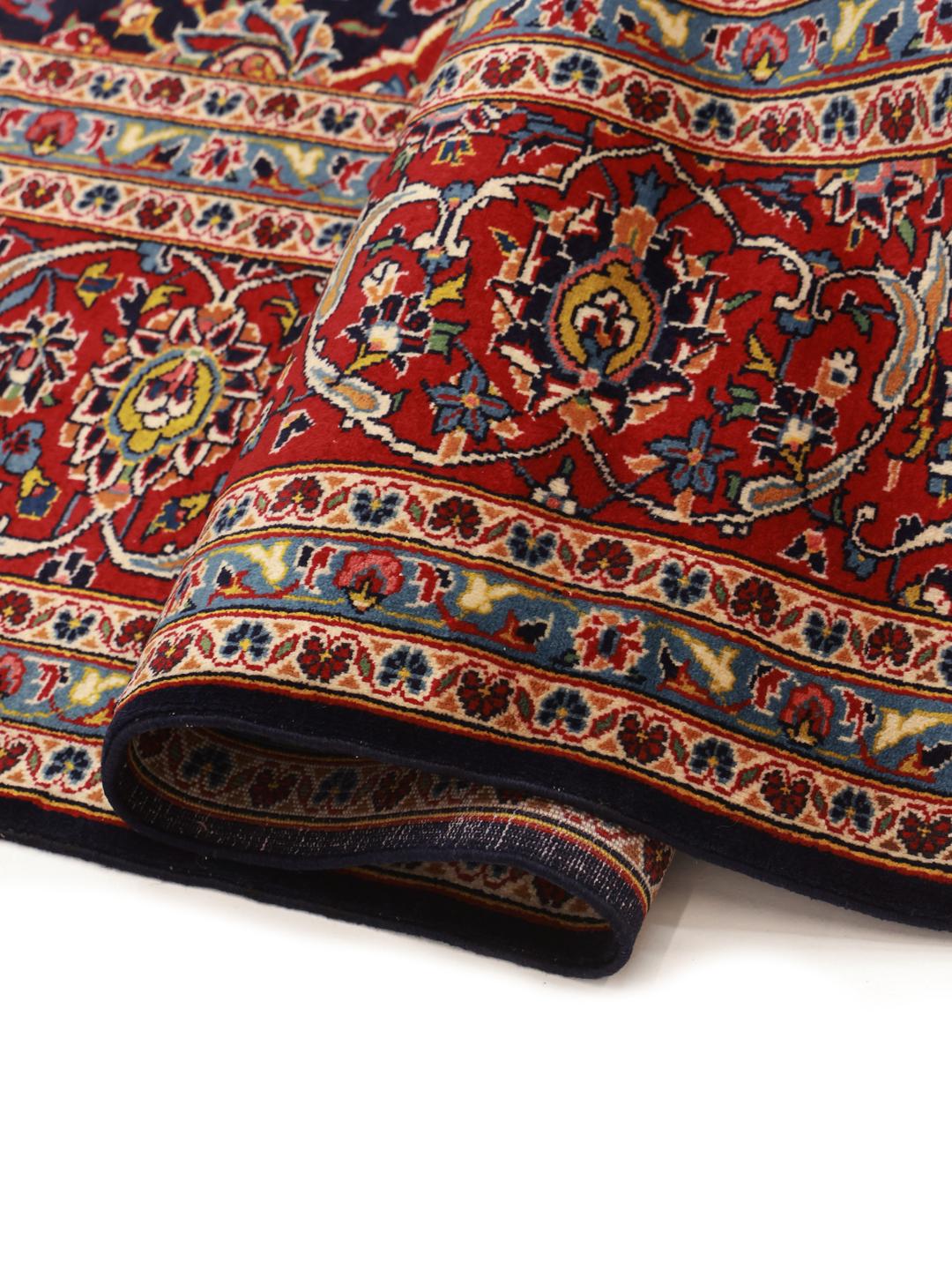 Hand-knotted Keshan rug from the Middle East in dark red and dark blue tones