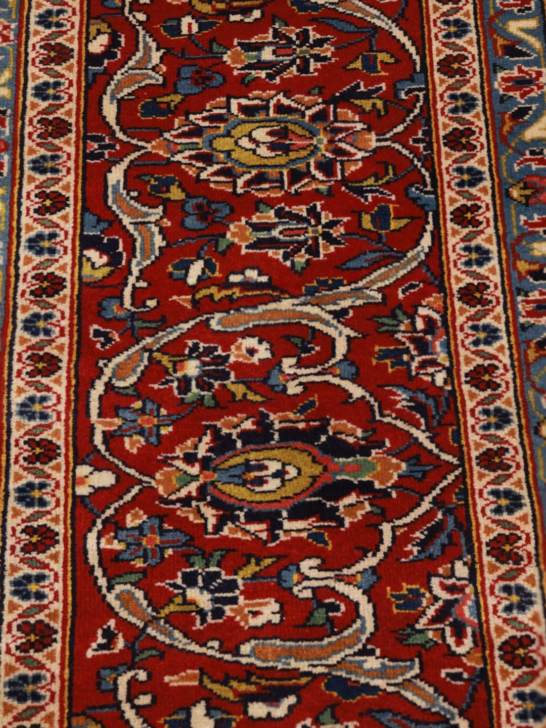 Hand-knotted Keshan rug from the Middle East in dark red and dark blue tones