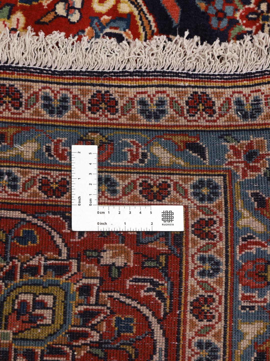 Hand-knotted Keshan rug from the Middle East in dark red and dark blue tones