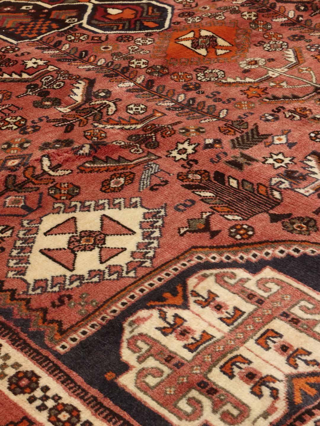 Hand-knotted Shiraz rug from the Middle East in vibrant red and earthy tones