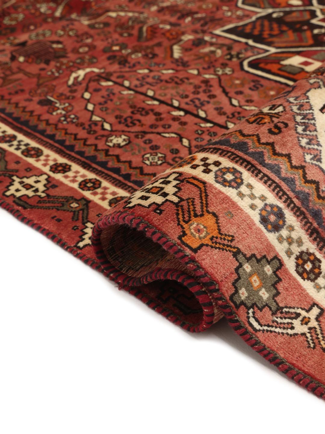 Hand-knotted Shiraz rug from the Middle East in vibrant red and earthy tones