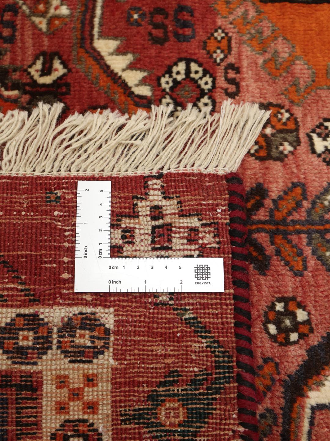 Hand-knotted Shiraz rug from the Middle East in vibrant red and earthy tones