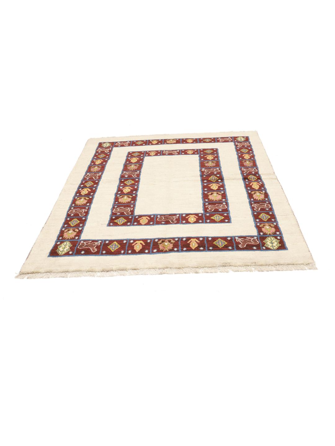 A hand-knotted Middle Eastern Shabargan rug in beige with dark red and blue accents.