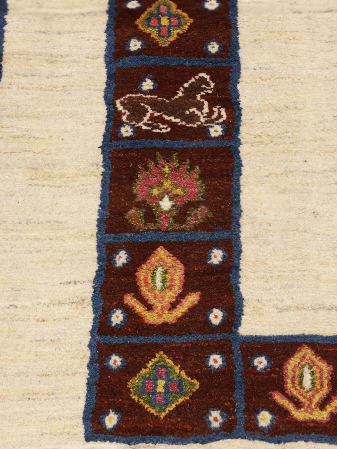 A hand-knotted Middle Eastern Shabargan rug in beige with dark red and blue accents.
