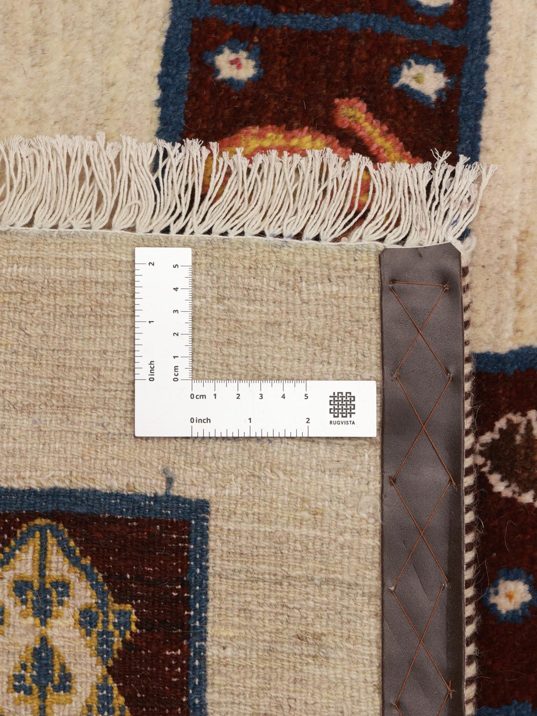 A hand-knotted Middle Eastern Shabargan rug in beige with dark red and blue accents.
