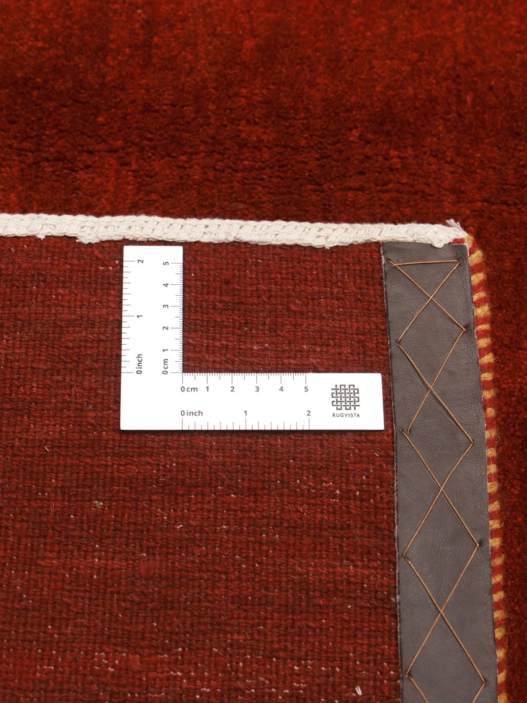 Un tapis Gabbeh rouge foncé vibrant venant du Moyen-Orient avec un velours de laine doux.